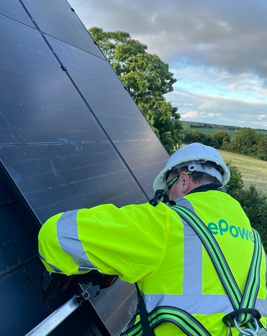 Background image a man installing solar panels